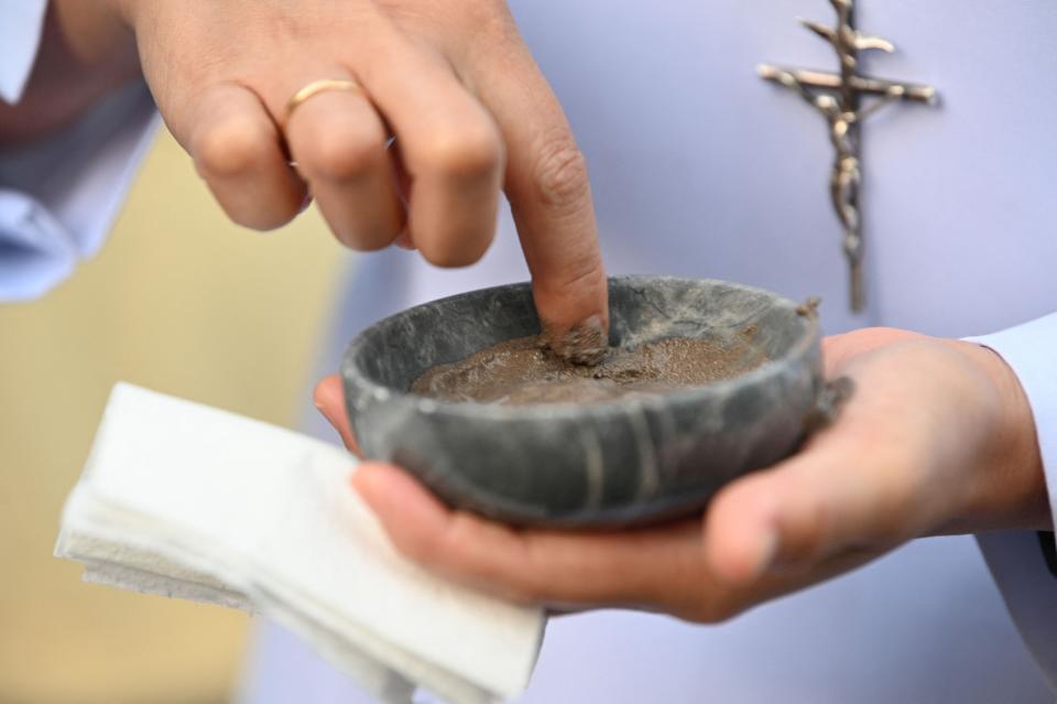 A Catholic nun prepares ash to be applied on Catholic faithful foreheads on the observance of Ash Wednesday at a church ground in Paranaque City suburban Manila on Feb. 22, 2023.