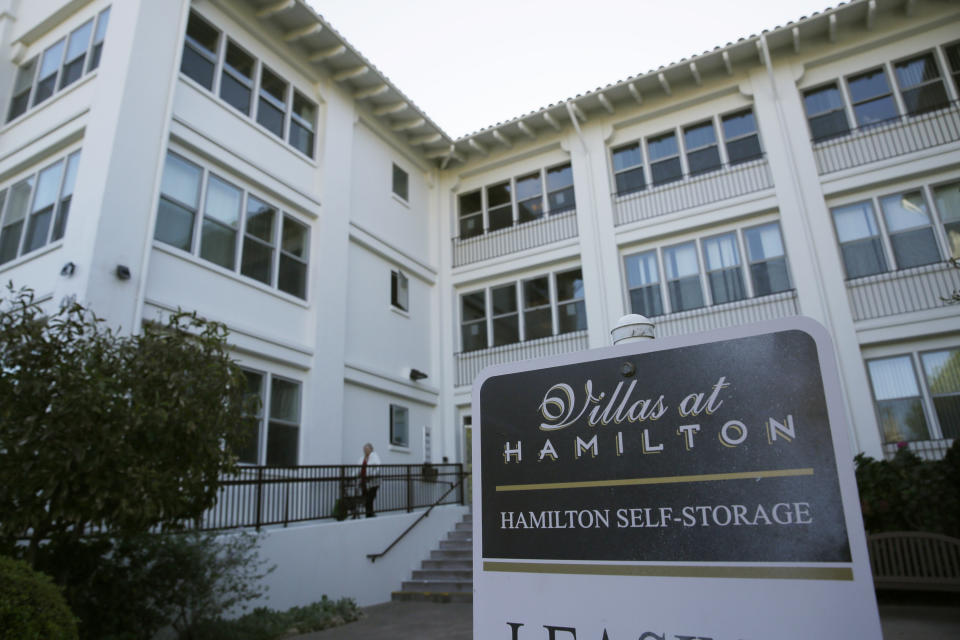 A woman makes her way out of the Villas at Hamilton housing complex Wednesday, Oct. 30, 2019, in Novato, Calif., where many low income seniors were stranded in the dark during the power blackouts. Pacific Gas & Electric officials said they understood the hardships caused by the blackouts but insisted they were necessary. (AP Photo/Eric Risberg)