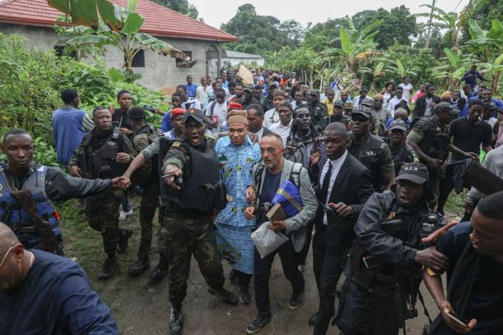 Kylian Mbappé surrounded by Cameroonian security forces, family and well-wishers.