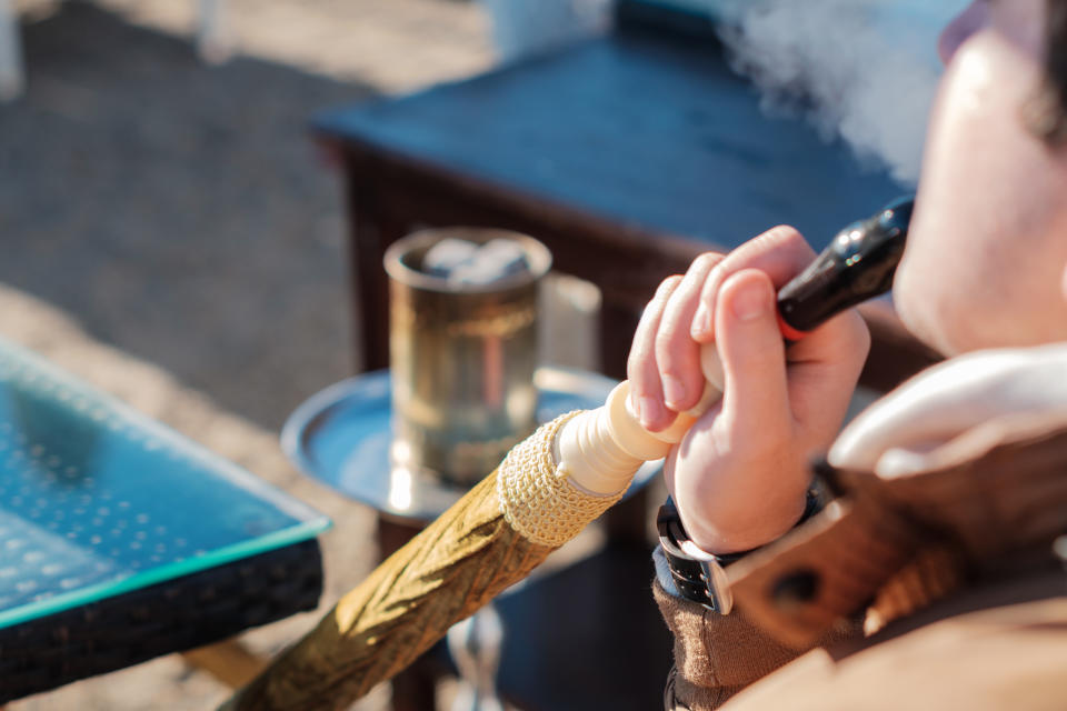 A man is pictured smoking shisha.