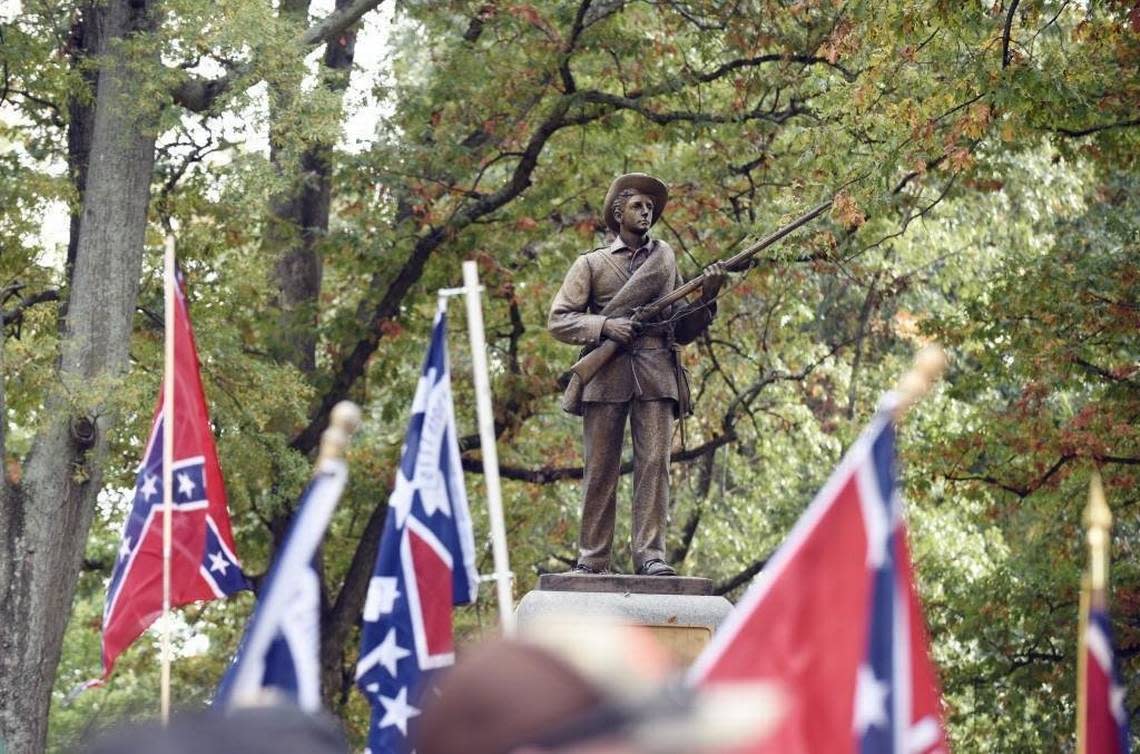 Confederate flags frame the confederate soldier monument known as “Silent Sam” during a rally on UNC campus in Chapel Hill, N.C. on Sunday, October 25, 2015. Protesters tore down the statue in 2018.