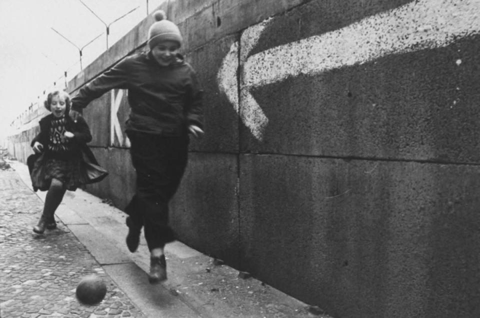 Not originally published in LIFE. Children chase a ball beside the Berlin Wall in December 1962. (Paul Schutzer—Time & Life Pictures/Getty Images) <br> <br> <a href="http://life.time.com/history/berlin-wall-photos-early-days-of-the-cold-war/#1" rel="nofollow noopener" target="_blank" data-ylk="slk:Click here to see the full collection at LIFE.com;elm:context_link;itc:0;sec:content-canvas" class="link ">Click here to see the full collection at LIFE.com</a>