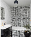 <p> Simplistic in its 3-color design, this black, white, and gold Hollywood Regency gut renovation screams class sophistication and luxury. </p> <p> &apos;This dramatic black and white bath exude pure glitz and glamour,&apos; says Sherry Hope-Kennedy, founder of SHK Studios, and member of the International Interior Design Association (IIDA);&#xA0;American Society of Interior Designers (ASID), California North Chapter,&#xA0;where she recently served as president; and San Francisco Design Center. </p> <p> &apos;Geometric striped tiles create a texture-rich background for the tub surround and floor. Shiny black surfaces &#x2013; lacquered vanity, table, and pendant lamp &#x2013; pair with gold-plated fixtures, and a heavily veined marble-tiled shower.&apos; </p>