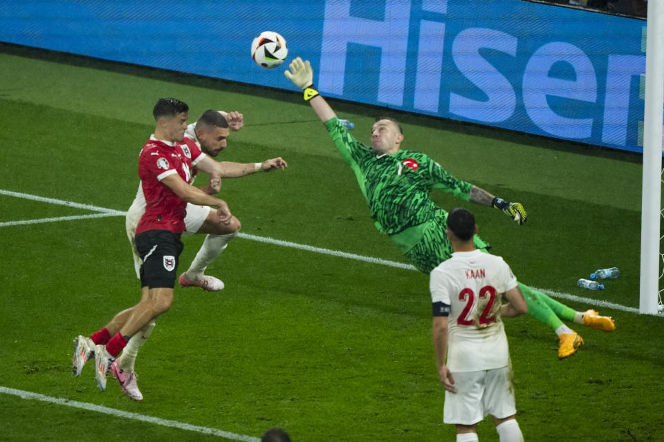 Turkey's goalkeeper Mert Gunok saves the ball during a round of sixteen match between Austria and Turkey at the Euro 2024 soccer tournament in Leipzig, Germany, Tuesday, July 2, 2024. (AP Photo/Ebrahim Noroozi)