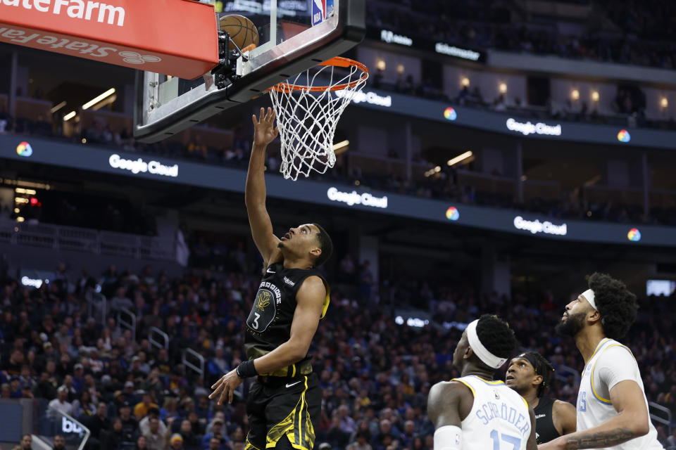 Golden State Warriors guard Jordan Poole (3) shoots against Los Angeles Lakers guard Dennis Schroder (17) during the first half of an NBA basketball game in San Francisco, Saturday, Feb. 11, 2023. (AP Photo/Jed Jacobsohn)