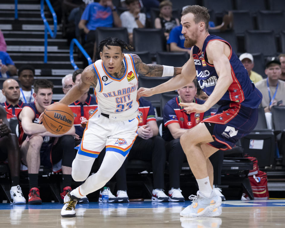 Oklahoma City Thunder's Tre Mann (23) goes against Adelaide 36ers' Anthony Drmic during the second half of a preseason NBA basketball game Thursday, Oct. 6, 2022, in Oklahoma City. (AP Photo/Garett Fisbeck)