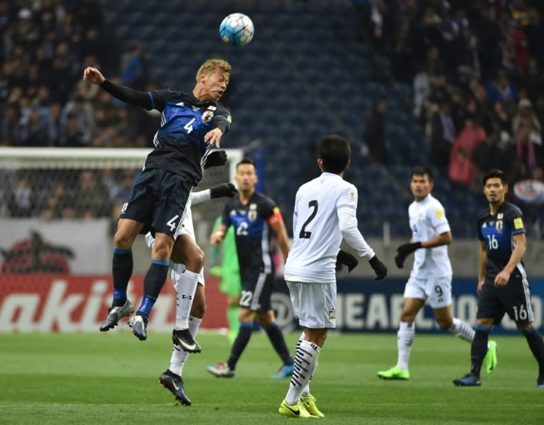 Japan’s forward Keisuke Honda (L) hits the ball on his head during group B World Cup 2018 qualifying football match between Japan and Thailand in Saitama on March 28, 2017