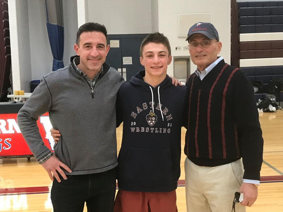 Jared Brunner (center) is a third generation wrestler in his family with father Jeremy (left) and grandfather Serge (right). Brunner captured his 100th career win on Friday night.