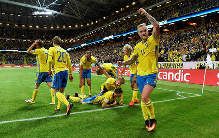 Football Soccer - Sweden vs Netherlands - 2018 World Cup Qualifier - Friends Arena, Stockholm, Sweden - 6/9/16. Sweden's John Guidetti (R) reacts after Marcus Berg's (C) 1-0 goal. TT News Agency/Pontus Lundahl/ via REUTERS