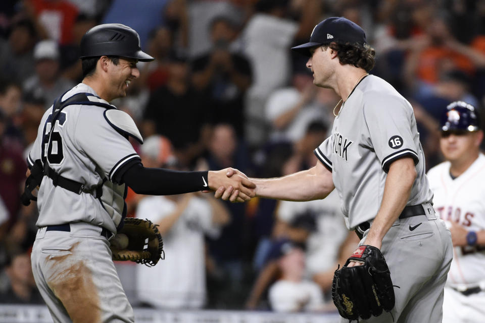 New York Yankees starting pitcher Gerrit Cole, right, shakes hands with catcher Kyle Higashioka after their win over the Houston Astros in a baseball game, Saturday, July 10, 2021, in Houston. (AP Photo/Eric Christian Smith)