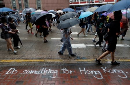 Protesters wearing masks gather during an anti-government rally at Causeway Bay, in Hong Kong