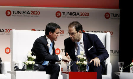 Tunisia's Prime Minister Youssef Chahed (R) shakes hands with his French counterpart Manuel Valls at the opening of international investment conference Tunisia 2020, in Tunis, Tunisia November 29, 2016. REUTERS/Zoubeir Souissi