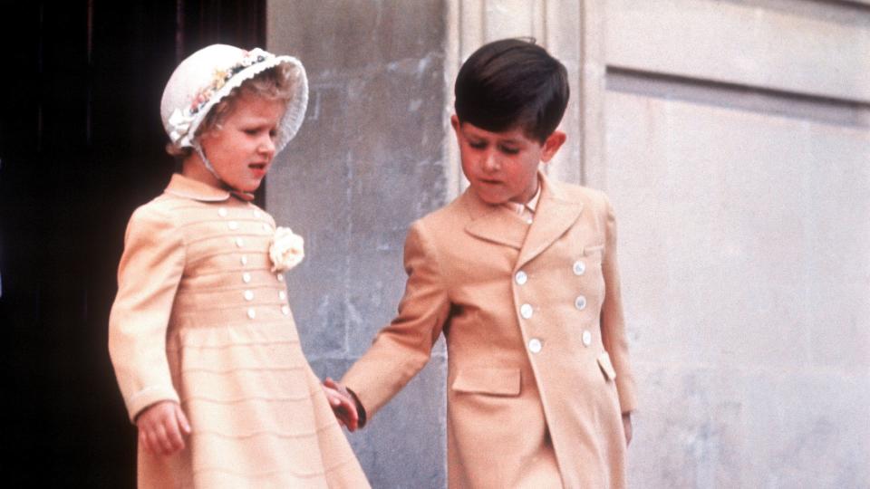 Young Princess Anne walking with young King Charles