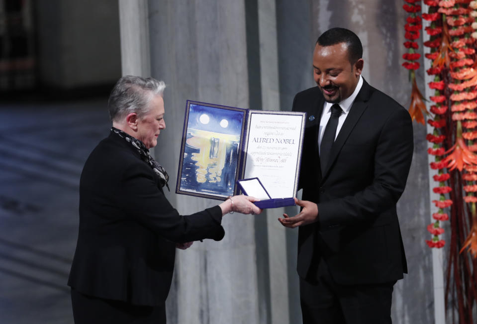 Ethiopia's Prime Minister Abiy Ahmed is presented by the Chair of the Nobel Committee Berit Reiss-Andersen, left, during the Nobel Peace Prize award ceremony in Oslo City Hall, Norway, Tuesday Dec. 10, 2019. (Terje Bendiksby/NTB Scanpix via AP)