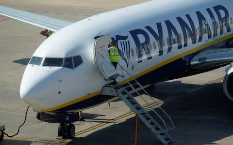 Ground staff enters a Ryanair plane - Credit:  HEINO KALIS/Reuters