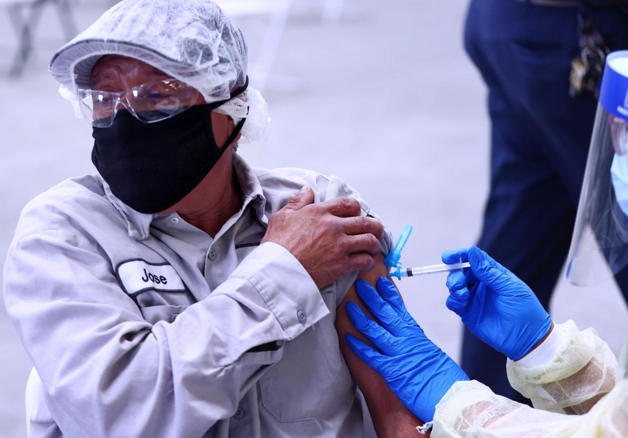 Jose Ortiz receives a one-shot dose of the Johnson & Johnson COVID-19 vaccine at a clinic geared toward agriculture workers organized by TODEC on April 5, 2021, in Riverside, Calif.