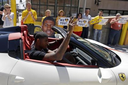 Paul George is greeted by Bankers Life Fieldhouse employees as he arrives for his news conference. (AP)