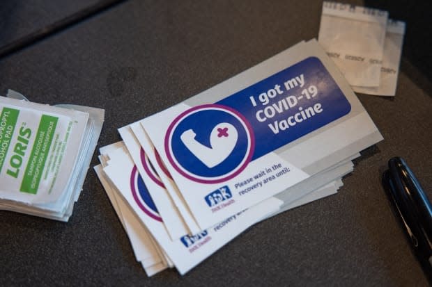 A pile of stickers that say 'I got my COVID-19 vaccine' lies on a table at the Halifax Convention Centre. The province reported two new cases of COVID-19 on Tuesday. (Robert Short/CBC - image credit)