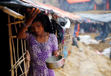A Rohingya refugee girl collects rain water at a makeshift camp in Cox's Bazar, Bangladesh, September 17, 2017. REUTERS/Mohammad Ponir Hossain