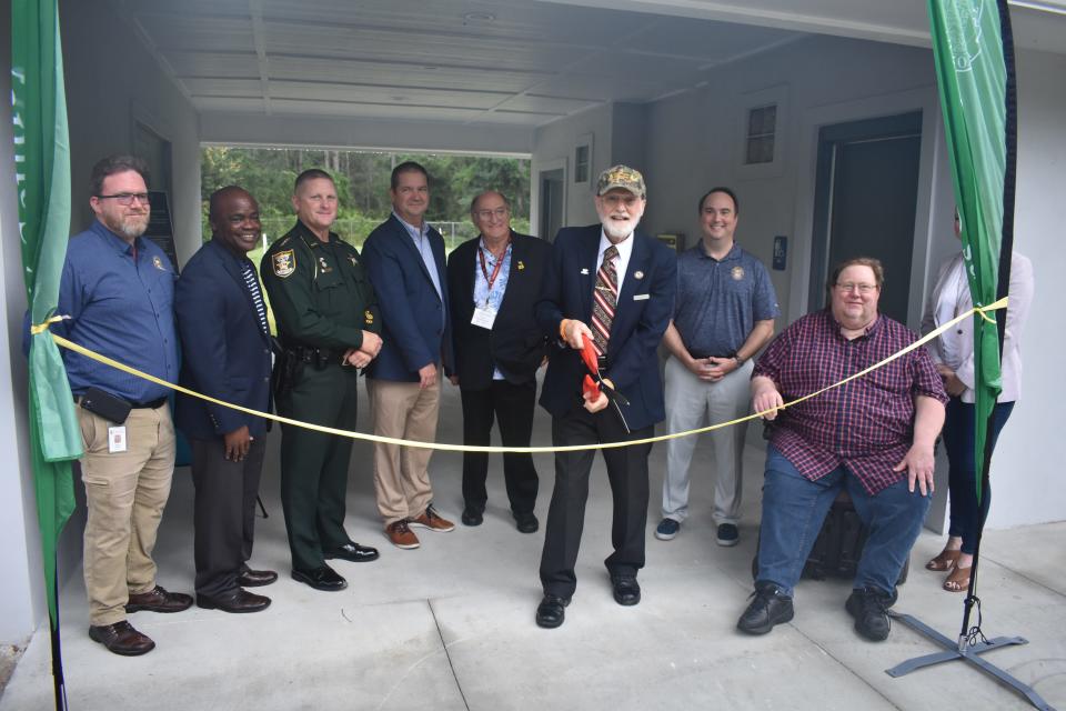 David Williams, Flagler Estates Community Redevelopment Area Steering Committee chair, prepares to cut a ribbon on Friday morning alongside other officials at the new Flagler Estates Community Center.