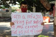 A Syrian refugee holds a placard during a sit-in, in Beirut