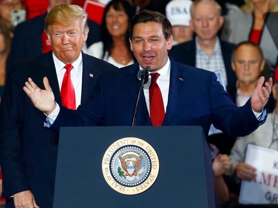 In this November 3, 2018 file photo, then-President Donald Trump stands behind Ron DeSantis during a rally in Pensacola, Florida, during his first gubernatorial run.