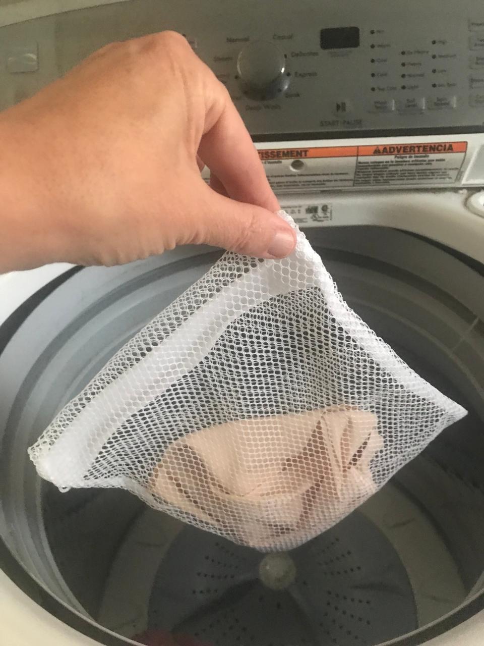 The reviewer places her Prettywell Sleep Bra in the washing machine.