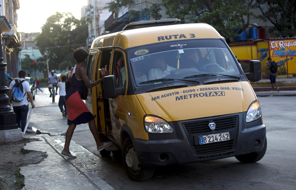 A Russian-made Gacela minibus stops for a passenger in Havana, Cuba, Wednesday, Oct. 23, 2019. Over the last year Russia has sent Cuba 1,000 minibuses, 50 locomotives, tens of thousands of tourists and a promise to upgrade the island’s power grid with a multi-million dollar improvement plan. (AP Photo/Ismael Francisco)