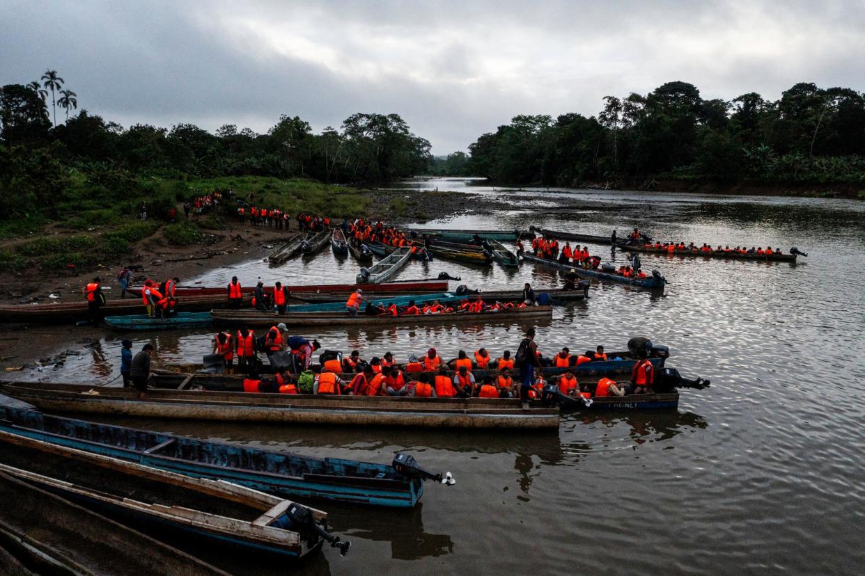 <span>People queue to be transported from Canaan Membrillo village to the Migrants Reception Station in Meteti, Darien Province, Panama, on 13 October 2022.</span><span>Photograph: Luis Acosta/AFP via Getty Images</span>