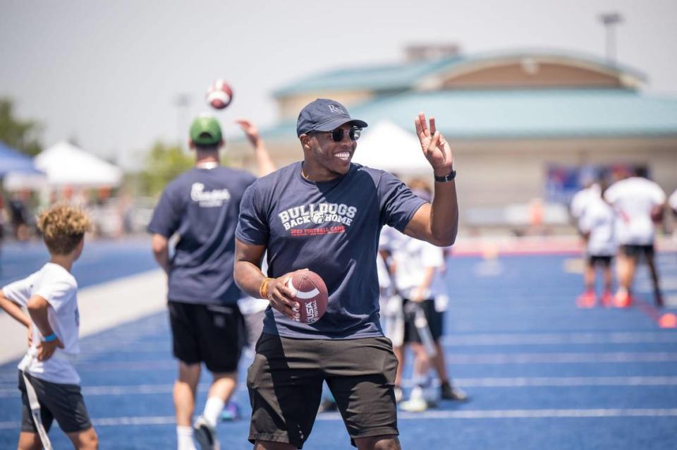 Former NFL player and Folsom Bulldog Jordan Richards gets the attention of one of the children during an agility drill at the Bulldogs Back Home 2023 football camp on Saturday, June 17, 2023, at Folsom High School. Alongside Richards, current NFL players and former Bulldogs Jack Browning, Josiah Deguara and Jonah Williams worked with children at the camp.