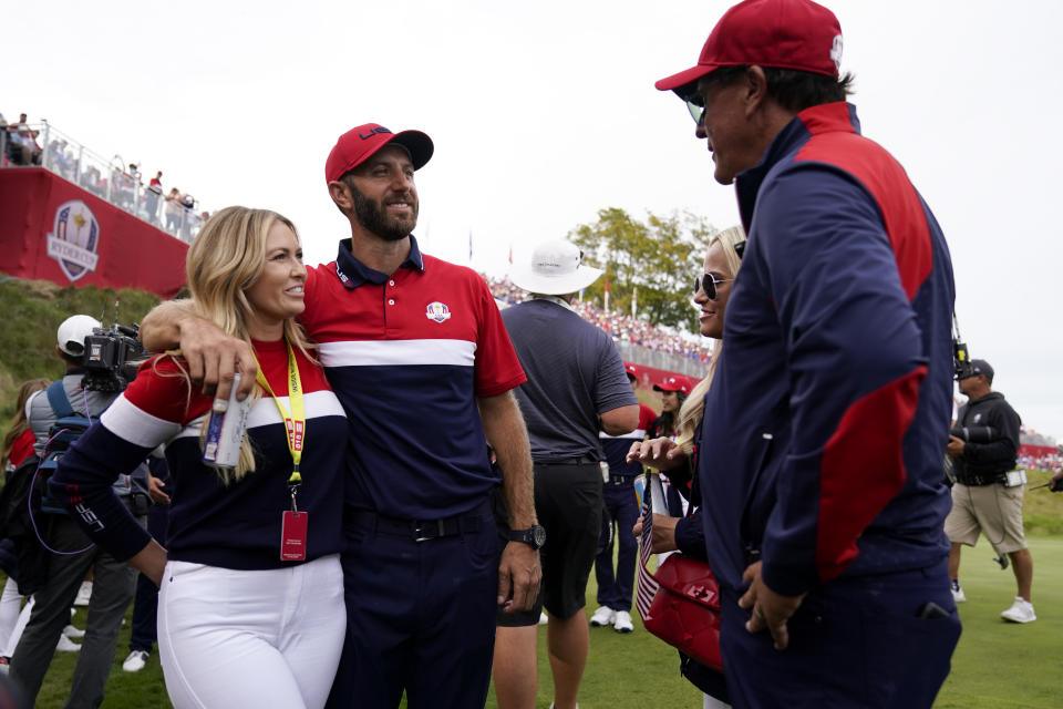 Team USA assistant captain Phil Mickelson talks to Team USA's Dustin Johnson and Paulina Gretzky after a Ryder Cup singles match at the Whistling Straits Golf Course Sunday, Sept. 26, 2021, in Sheboygan, Wis. (AP Photo/Ashley Landis)