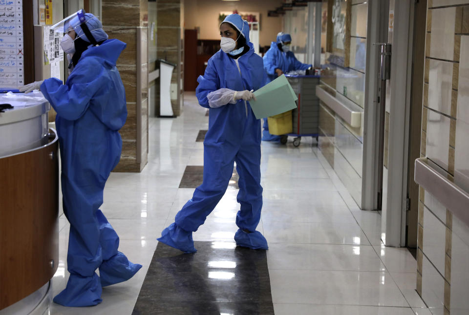 In this Tuesday, June 16, 2020, photo, nurses work in a COVID-19 ward of the Shohadaye Tajrish Hospital in Tehran, Iran. After months of fighting the coronavirus, Iran only just saw its highest single-day spike in reported cases after Eid al-Fitr, the holiday that celebrates the end of Ramadan. (AP Photo/Vahid Salemi)