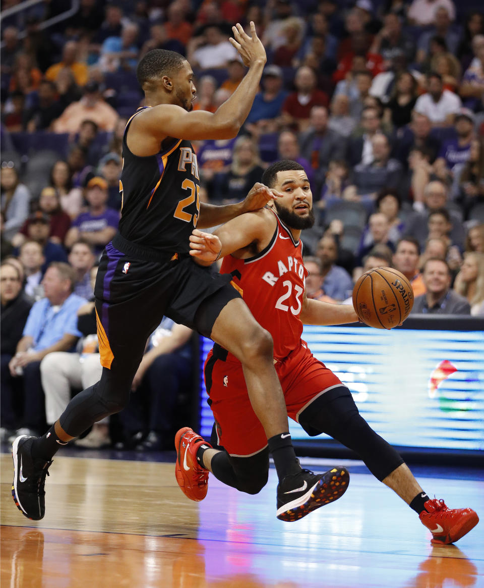 Toronto Raptors guard Fred VanVleet (23) drives past Phoenix Suns forward Mikal Bridges (25) during the first half of an NBA basketball game, Friday, Nov. 2, 2018, in Phoenix. (AP Photo/Matt York)