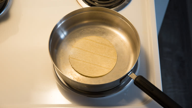 corn tortilla warming in skillet 