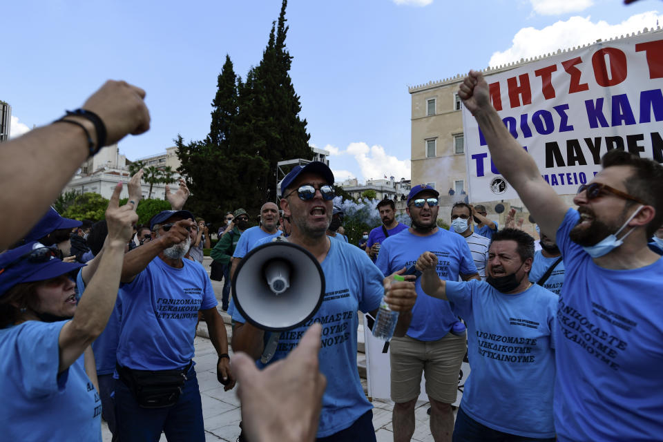 Protesters shout slogans as they take part in a rally during a 24-hour labor strike, in Athens, Thursday, June 10, 2021. Widespread strikes in Greece brought public transport and other services to a halt Thursday, as the country's largest labor unions protested against employment reforms they argue will make flexible workplace changes introduced during the pandemic more permanent. (AP Photo/Michael Varaklas)