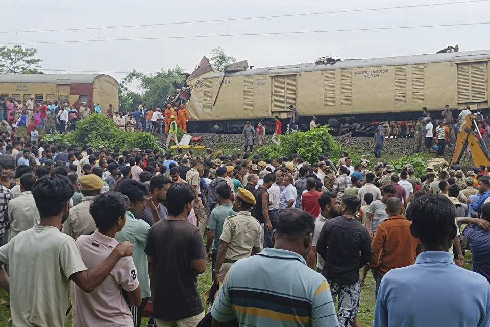 Onlookers watch as rescuers work after a cargo train rammed into Kanchanjunga Express, a passenger train, near New Jalpaiguri station, West Bengal state, India, Monday, June 17, 2024. (AP Photo/Diptendu Dutta)