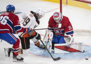 Anaheim Ducks' Troy Terry (19) moves in against Montreal Canadiens goaltender Sam Montembeault as Canadiens' Jeff Petry defends during third-period NHL hockey game action in Montreal, Thursday, Jan. 27, 2022. (Graham Hughes/The Canadian Press via AP)