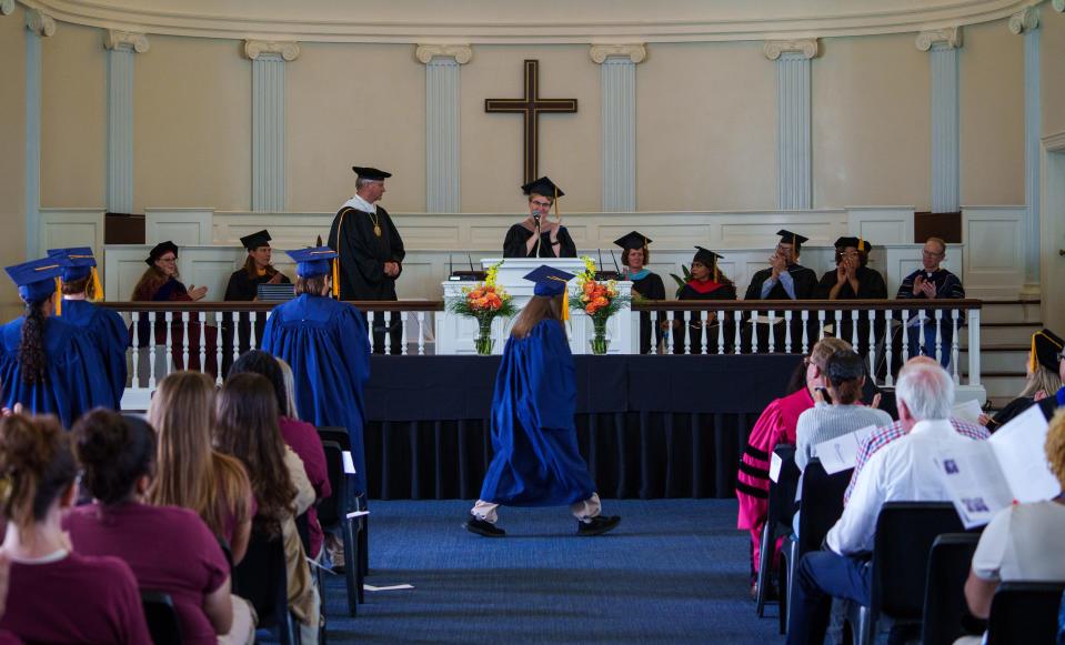 Elizabeth Osika, an assistant provost at Marian University, reads the names of graduates Monday, Aug. 7, 2023, inside the chapel at the Indiana Women's Prison in Indianapolis. The Women's College Partnership, which began in 2019, is a collaboration between Marian University and the University of Notre Dame offering a liberal arts education to those at the prison.