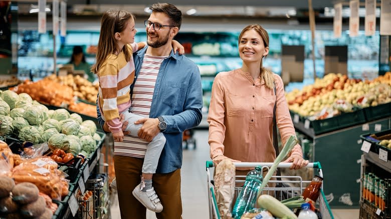 couple and child grocery shoppping