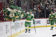 Minnesota Wild left wing Kirill Kaprizov (97) high-fives teammates on the bench after scoring against the Nashville Predators during the second period of an NHL hockey game Sunday, March 10, 2024, in St. Paul, Minn. (AP Photo/Stacy Bengs)