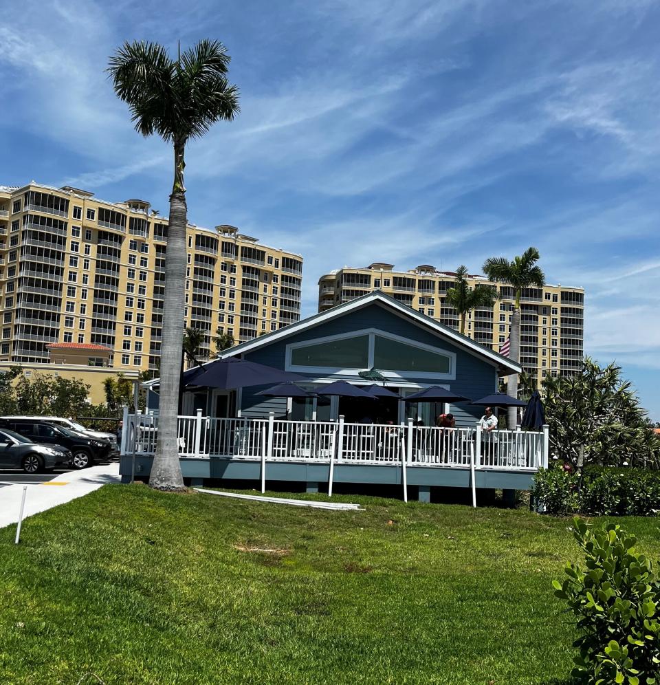 High Tide Social House is an inviting open-air waterfront restaurant with a tin roof, wrap-around porch and spectacular views of Tarpon Point Marina and Glover Bight.