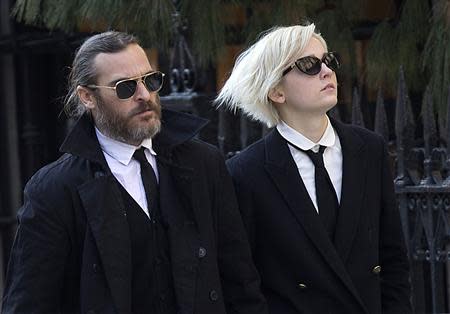 Actor Joaquin Phoenix (L) arrives for actor Philip Seymour Hoffman's funeral at St. Ignatius church in the Manhattan borough of New York February 7, 2014. REUTERS/Carlo Allegri