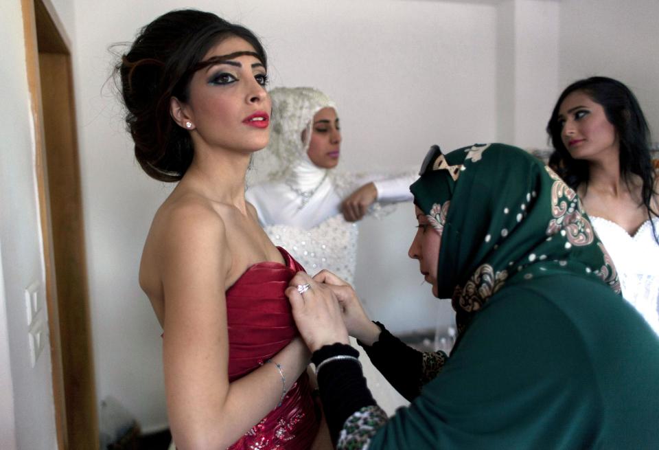 In this photo taken Thursday, May 1, 2014, a model backstage is prepared to display a creation by designer Fayzeh Pearl ahead the opening day of the Palestine Fashion Week 2014, in the West Bank city of Ramallah. While Ramallah is not internationally known for fashion, organizers hope that its Palestinian Fashion Week will draw more attention to local designers. (AP Photo/Nasser Nasser)
