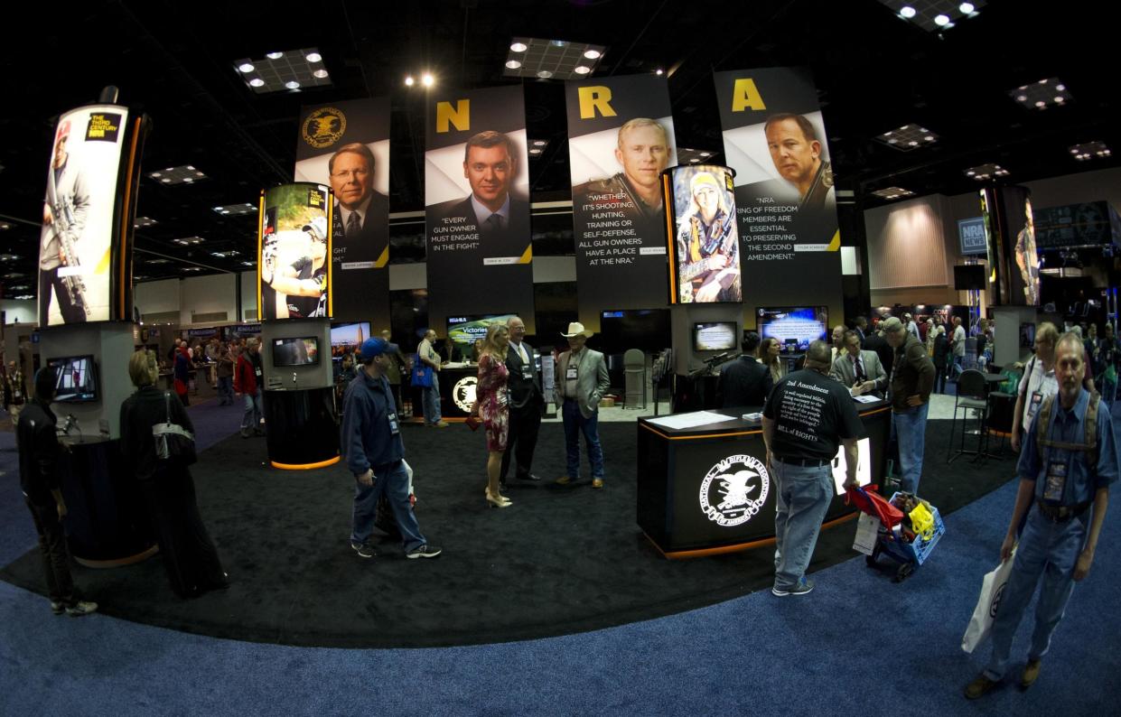 Convention goers walk through the NRA booth at the143rd NRA Annual Meetings and Exhibits at the Indiana Convention Center: KAREN BLEIER/AFP/Getty Images
