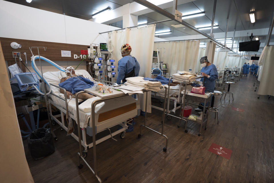 Health workers treat patients at the Ajusco Medio General Hospital which is designated for COVID-19 cases only, in Mexico City, Tuesday, Aug. 31, 2021. (AP Photo/Marco Ugarte)