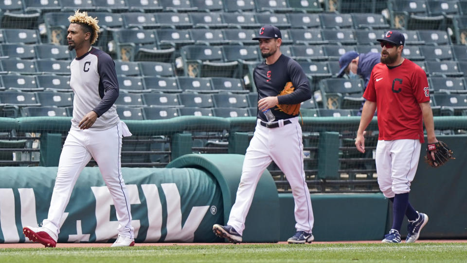 Cleveland Indians relief pitchers, from left, Emmanuel Clase, Nick Wittgren and Bryan Shaw walk off the field after the a baseball game between the Toronto Blue Jays and the Cleveland Indians was postponed due to inclement weather, Saturday, May 29, 2021, in Cleveland. The game will be rescheduled as a traditional doubleheader Sunday. (AP Photo/Tony Dejak)