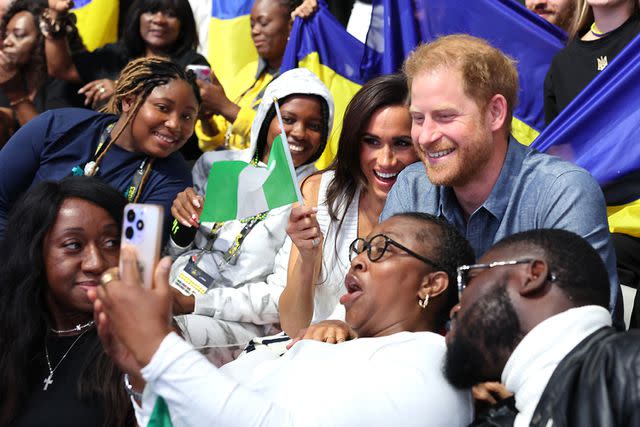 <p>Chris Jackson/Getty Images for the Invictus Games Foundation</p> Meghan Markle and Prince Harry pose for photos at the Invictus Games in Dusseldorf, Germany on Sept. 14, 2023.