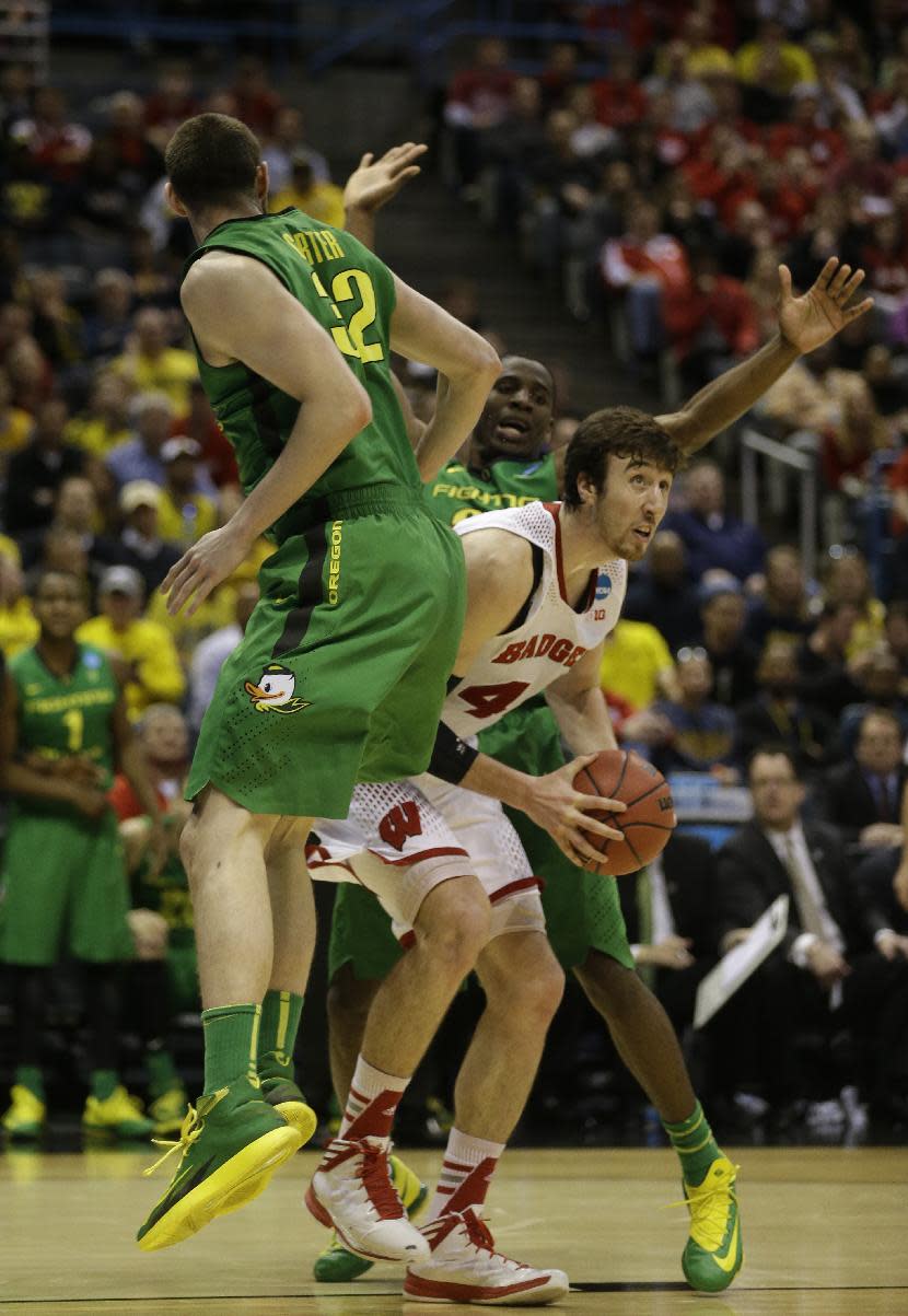 Wisconsin forward Frank Kaminsky (44) drives to the basket against Oregon- defense during the first half of a third-round game of the NCAA college basketball tournament Saturday, March 22, 2014, in Milwaukee. (AP Photo/Jeffrey Phelps)