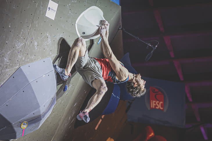 Adam Ondra celebrating after topping a bouldering world cup finals route in 2021