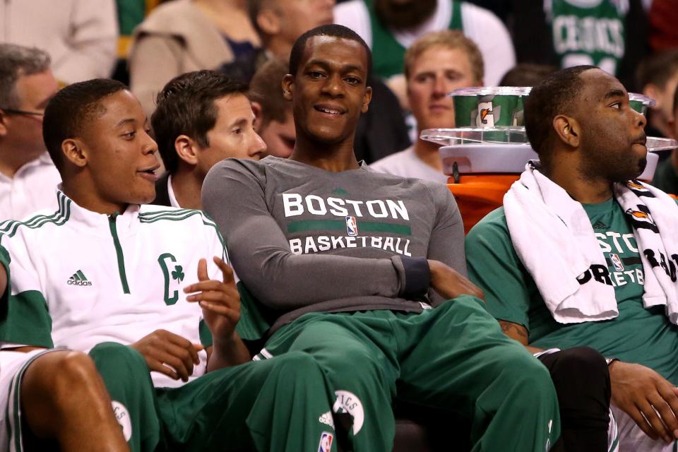 BOSTON, MA - OCTOBER 22: Rajon Rondo #9 of the Boston Celtics looks on from the bench with teammates against the Brooklyn Nets during a preseason game at TD Garden on October 22, 2014 in Boston, Massachusetts. NOTE TO USER: User expressly acknowledges and agrees that, by downloading and or using this photograph, User is consenting to the terms and conditions of the Getty Images License Agreement.  (Photo by Mike Lawrie/Getty Images)